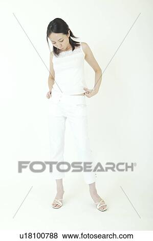 Stock Photo - A young woman standing. Fotosearch