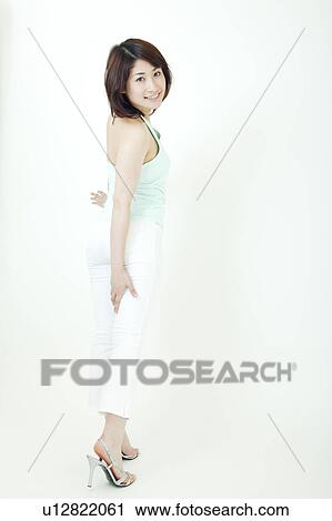 A young woman standing with smile View Large Photo Image Stock Image - A young woman standing with smile. Fotosearch