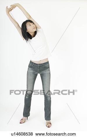 Stock Photo - A young woman stretching. Fotosearch