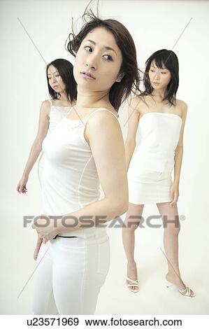 Stock Photo - Three confident women standing. Fotosearch