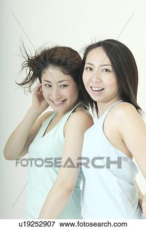 Two women smiling View Large Photo Image Stock Photo - Two women smiling. Fotosearch