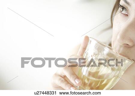 Stock Image - A young woman drinking. Fotosearch