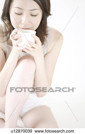 Stock Photo - A young woman drinking. Fotosearch