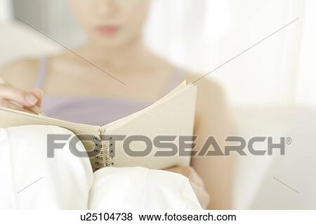 A young woman looking at a memo View Large Photo Image Stock Photo - A young woman looking at a memo. Fotosearch