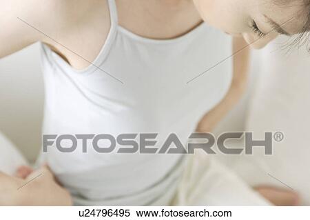 Stock Photography - A young woman looking down. Fotosearch