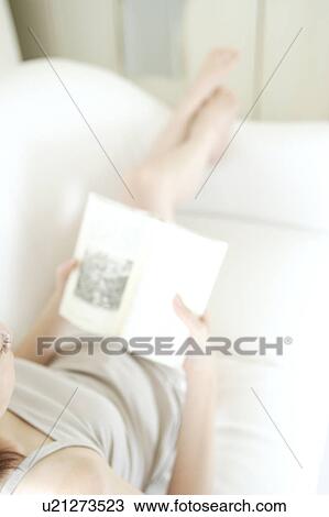 A young woman reading a book View Large Photo Image Stock Image - A young woman reading a book. Fotosearch