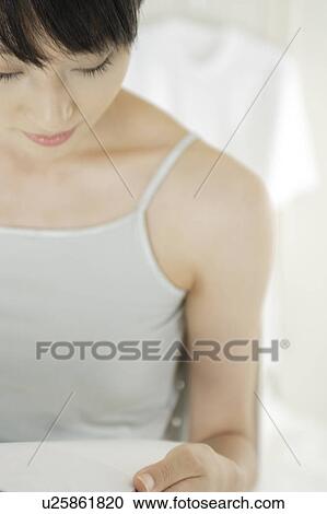 A young woman reading a book View Large Photo Image Stock Image - A young woman reading a book. Fotosearch