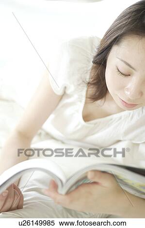 Stock Photography - A young woman reading. Fotosearch