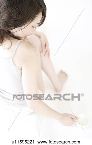 Stock Image - A young woman relaxing. Fotosearch