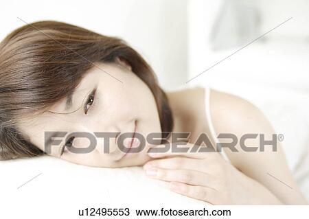 Stock Image - A young woman relaxing. Fotosearch