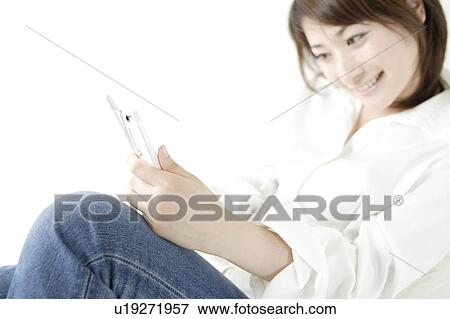 Stock Photo - A young woman sending E-Mail. Fotosearch