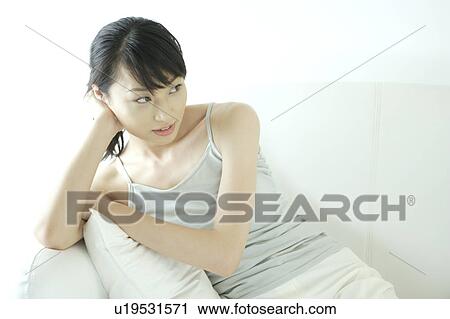 Stock Image - A young woman sitting. Fotosearch