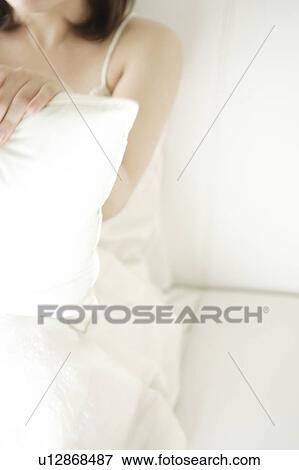 A young woman sitting View Large Photo Image Stock Photo - A young woman sitting. Fotosearch