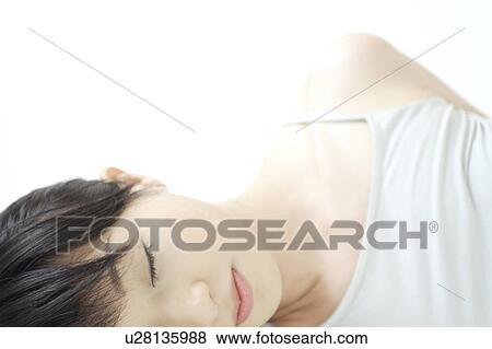 Stock Photo - A young woman sleeping. Fotosearch