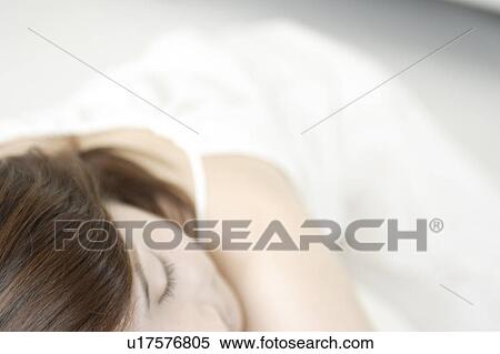 Stock Photography - A young woman sleeping. Fotosearch