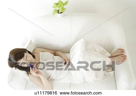 A young woman smelling aromatherapy oil View Large Photo Image Stock Photograph - A young woman smelling aromatherapy oil. Fotosearch