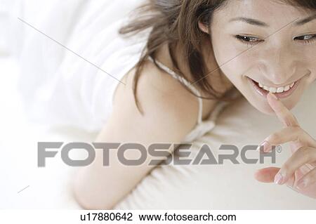 A young woman smiling View Large Photo Image Stock Image - A young woman smiling. Fotosearch