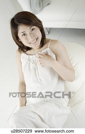 Stock Photo - A young woman smiling. Fotosearch