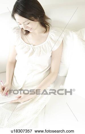 Stock Photo - A young woman writing a letter. Fotosearch