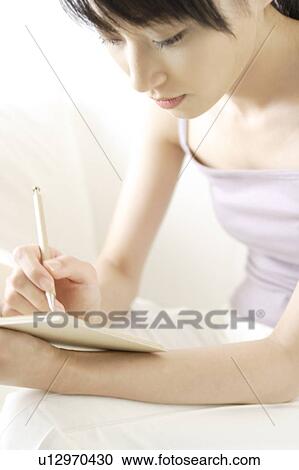 A young woman writing View Large Photo Image Stock Image - A young woman writing. Fotosearch