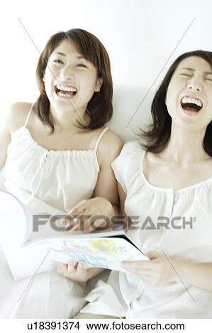 Two young women laughing View Large Photo Image Picture - Two young women laughing. Fotosearch