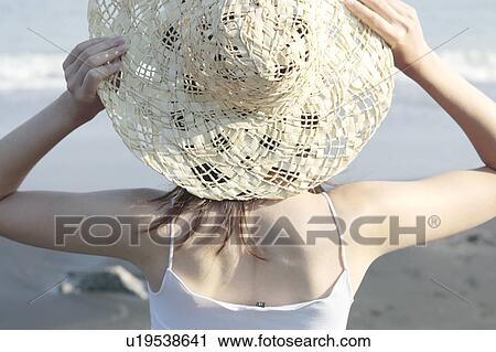 Stock Image - A young woman in a hat, rear view. Fotosearch