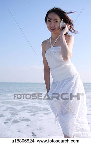 Picture - A young woman in beach. Fotosearch