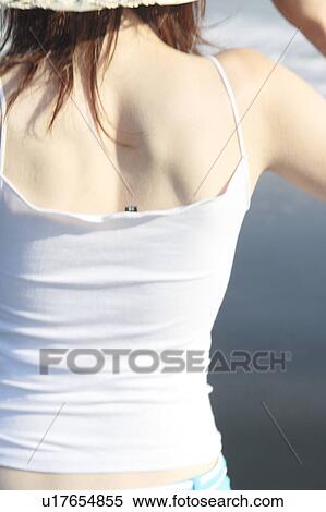 Stock Photography - A young woman in beach, rear view. Fotosearch
