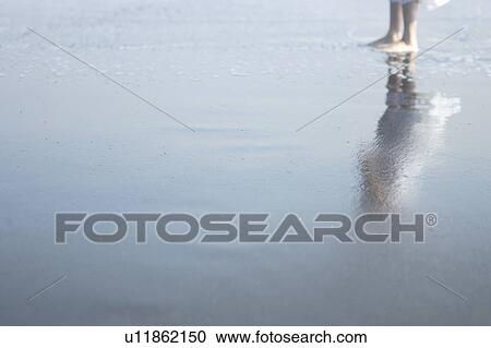 Stock Image - A young woman in beach. Fotosearch