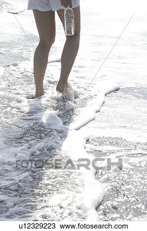 Stock Image - A young woman in beach. Fotosearch