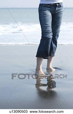 Stock Image - A young woman in beach. Fotosearch