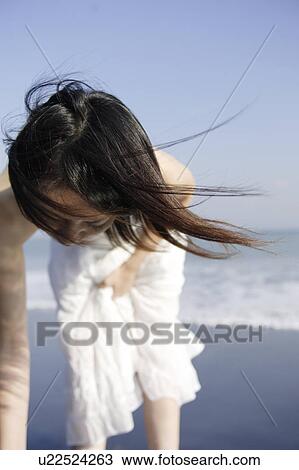 Stock Image - A young woman in beach. Fotosearch