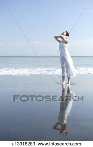 Stock Photo - A young woman in beach. Fotosearch