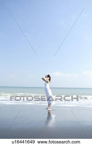 Stock Photo - A young woman in beach. Fotosearch