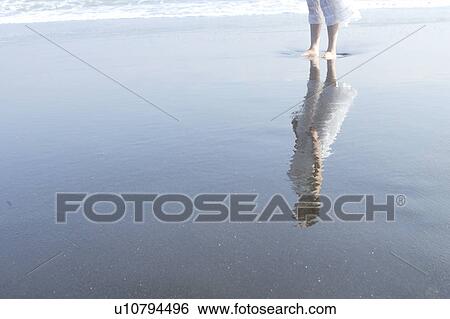 Stock Photograph - A young woman in beach. Fotosearch