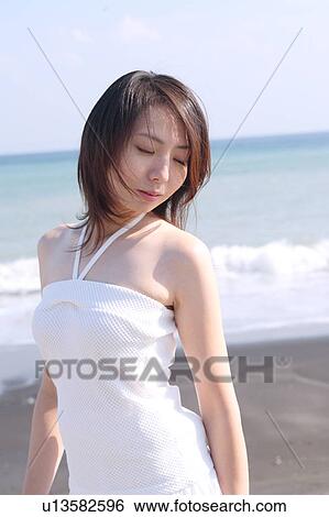 Stock Photograph - A young woman in beach. Fotosearch