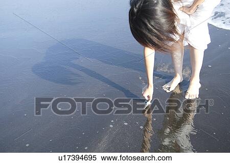 Stock Photography - A young woman in beach. Fotosearch