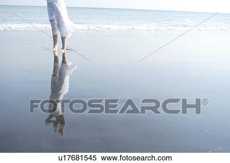 Stock Photography - A young woman in beach. Fotosearch