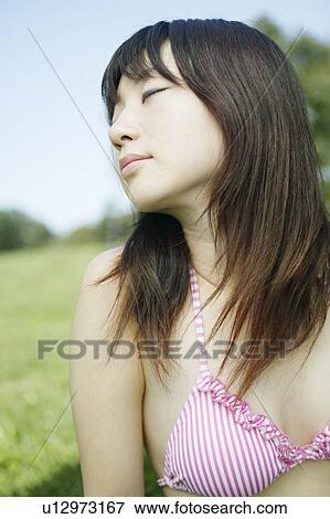 Stock Photo - A young woman in park. Fotosearch