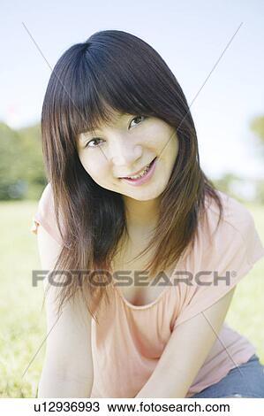 Stock Image - A young woman smiling. Fotosearch