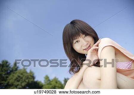 Stock Photo - A young woman smiling. Fotosearch