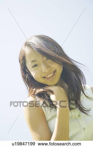 Stock Photo - A young woman smiling. Fotosearch