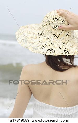 A young woman wearing a hat in beach View Large Photo Image Stock Photo - A young woman wearing a hat in beach. Fotosearch