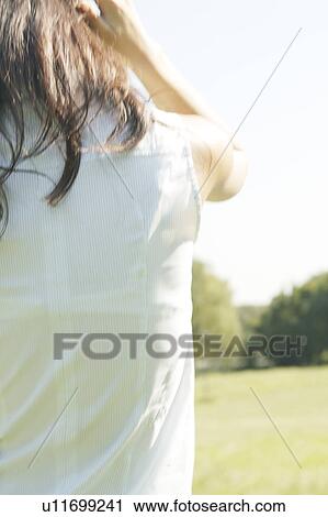 Stock Image - Rear view of a young woman. Fotosearch