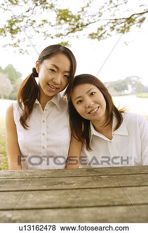 Two women in park View Large Photo Image Stock Photo - Two women in park. Fotosearch