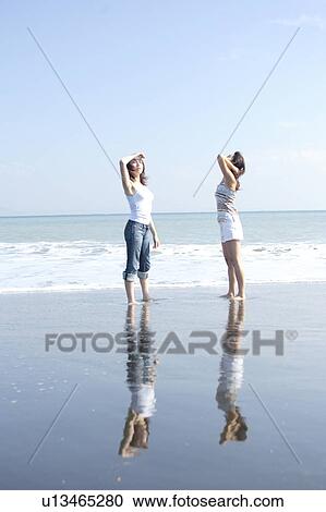 Two young women in beach View Large Photo Image Stock Image - Two young women in beach. Fotosearch