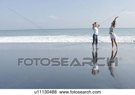Two young women in beach View Large Photo Image Stock Photo - Two young women in beach. Fotosearch