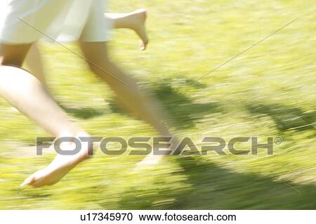 Stock Image - Young women running in park. Fotosearch