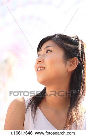Stock Photograph - A woman smiling, Ferris Wheel. Fotosearch