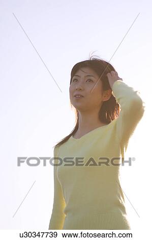 A woman standing View Large Photo Image Stock Photo - A woman standing. Fotosearch